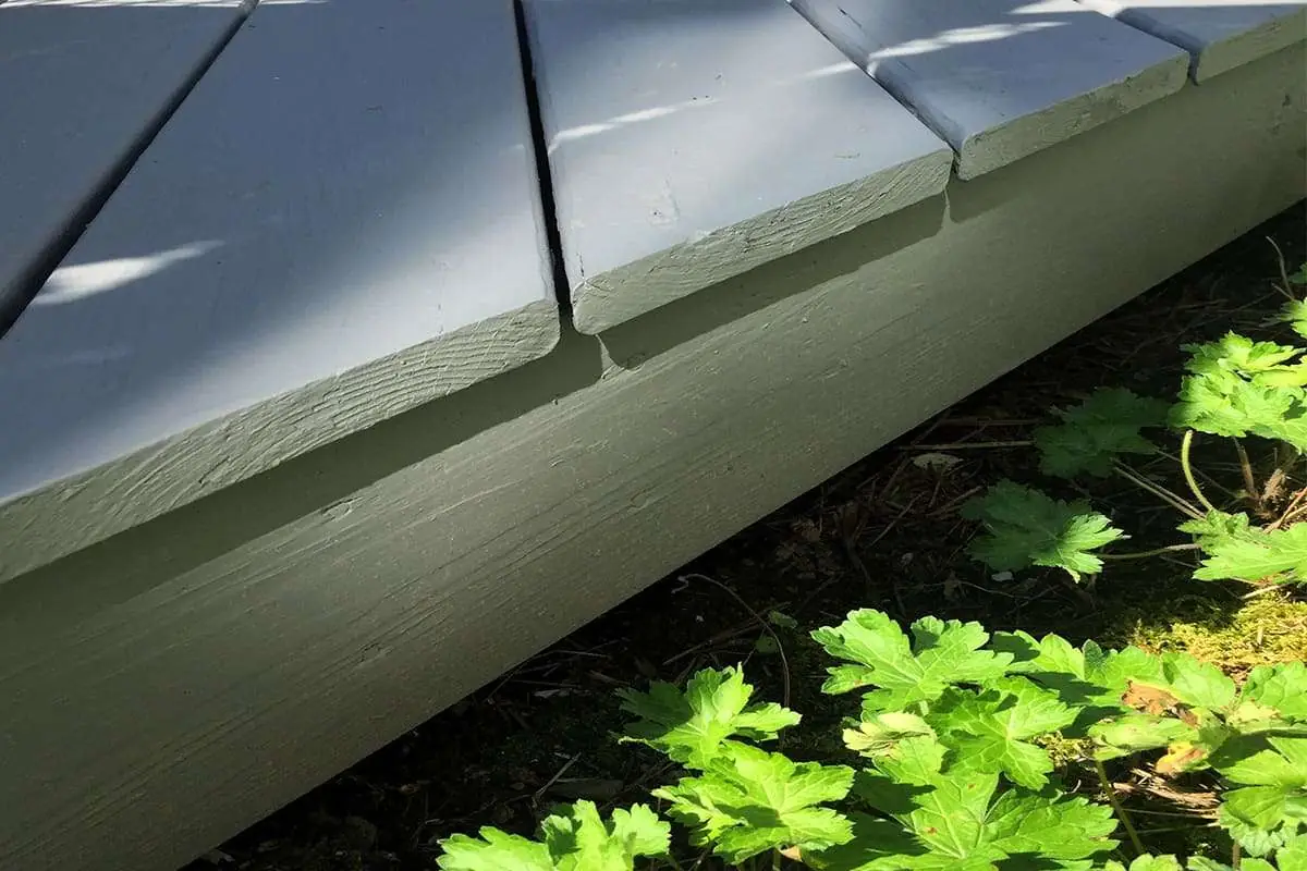 Gap under a deck where a skunk could make a den